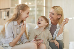Happy Mother with Two Girls at Home